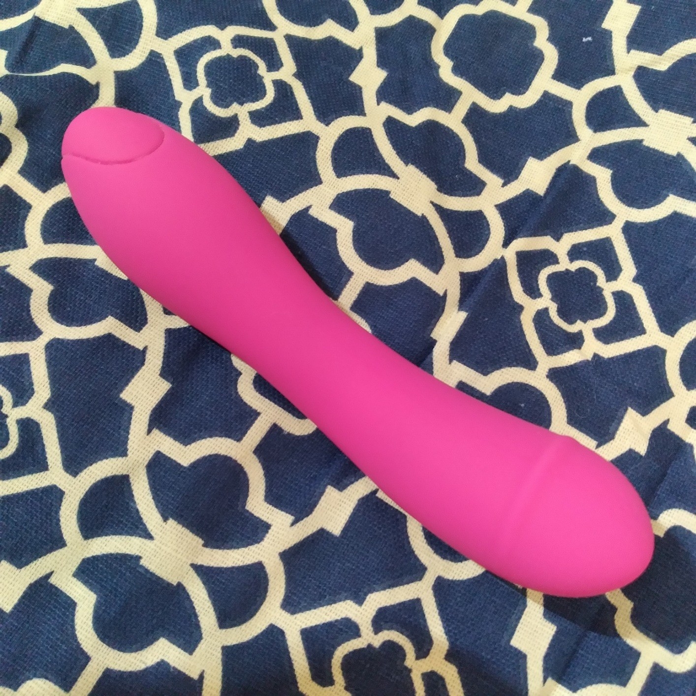 Pink vibrator on bed