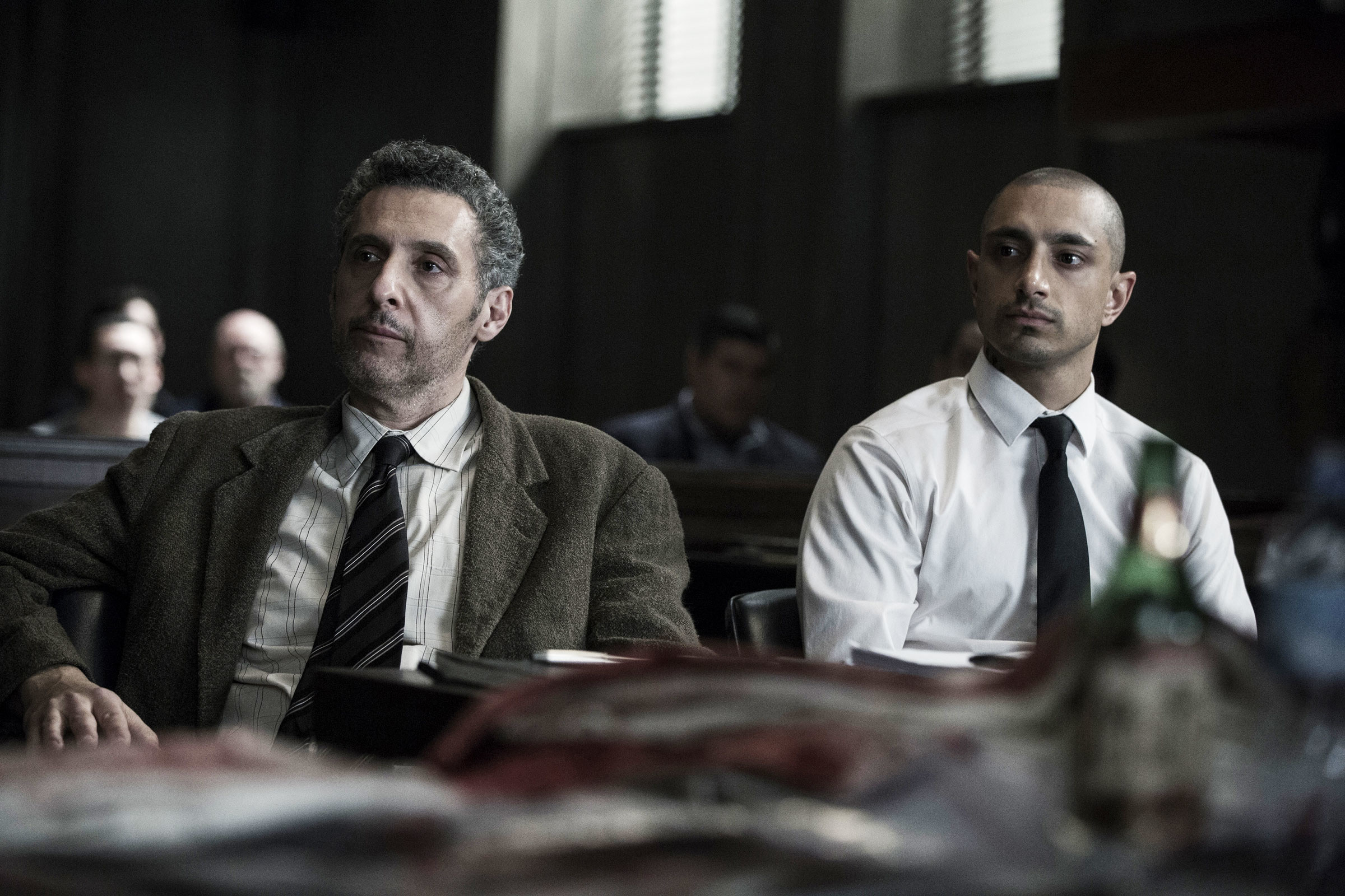 John Turturro as attorney John Stone sat next to Riz Ahmed as Nasir Khan in a court proceeding in &quot;The Night Of&quot;