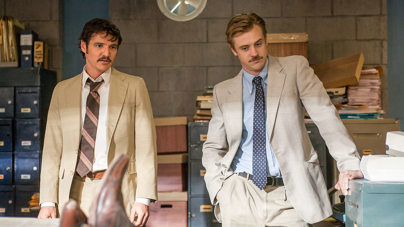 Pedro Pascal as DEA agent Javier Peña and Boyd Holbrook as agent Steve Murphy stood in an office in &quot;Narcos&quot;