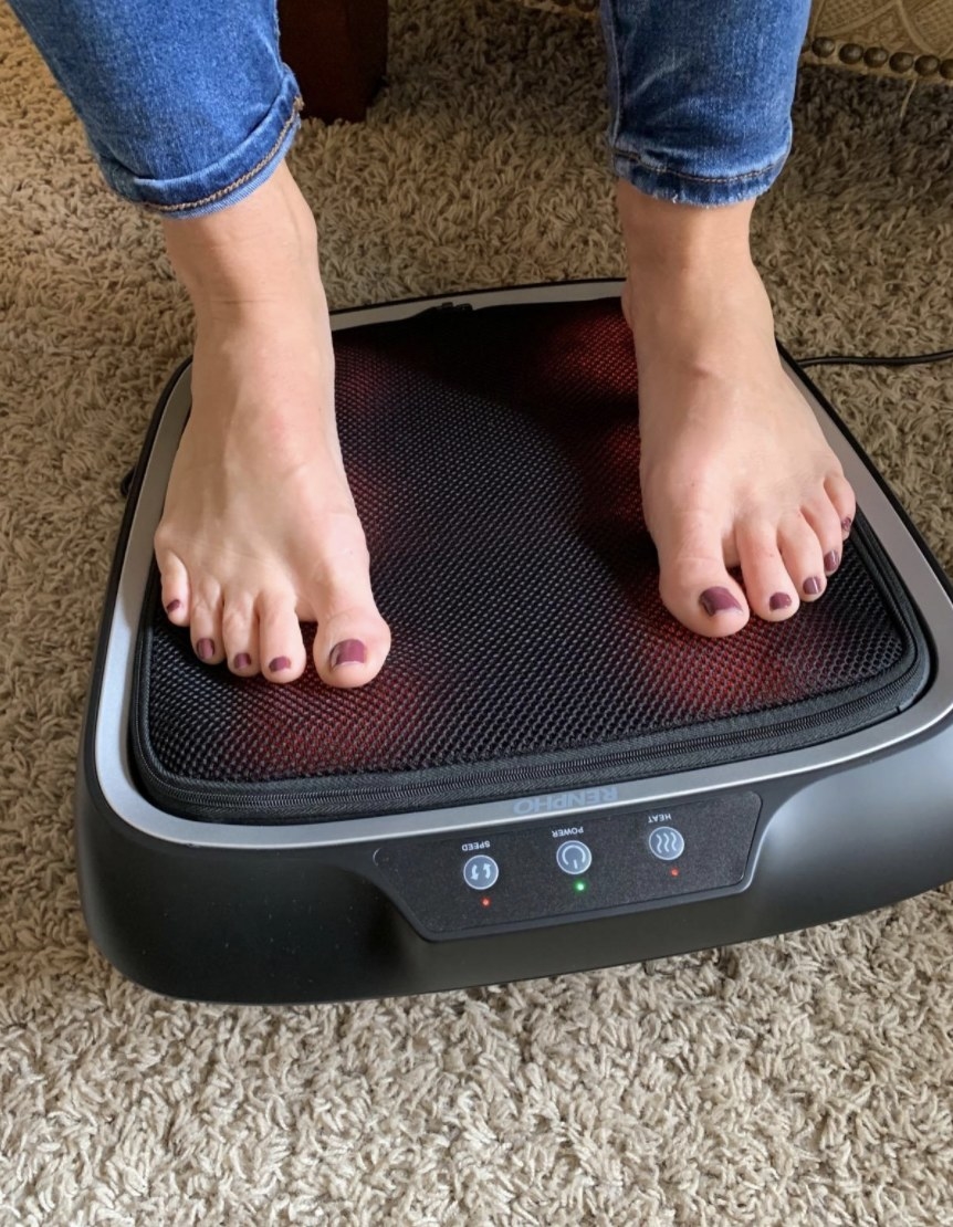 a person resting their feet on the foot massager