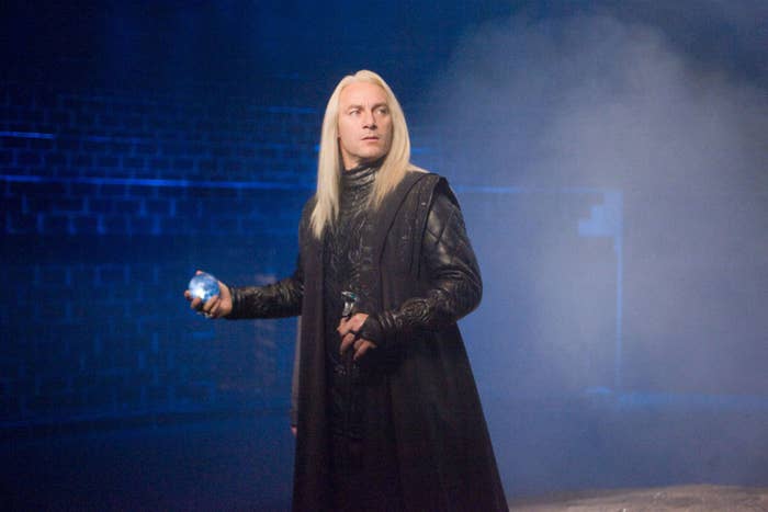 Lucius holding the prophecy in the department of mysteries