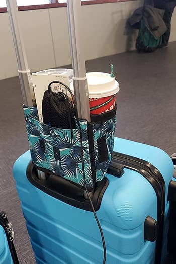the back view of the suitcase with the cup caddy mounted on it