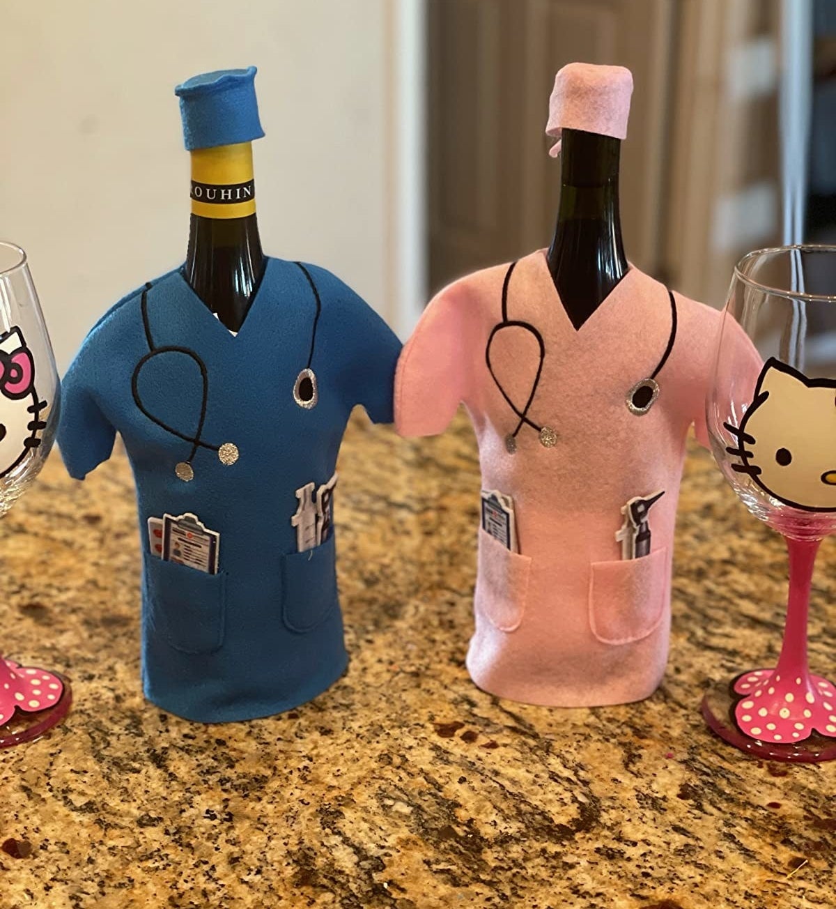 Reviewer photo of two bottles of wine, one in blue scrubs and the other in pink