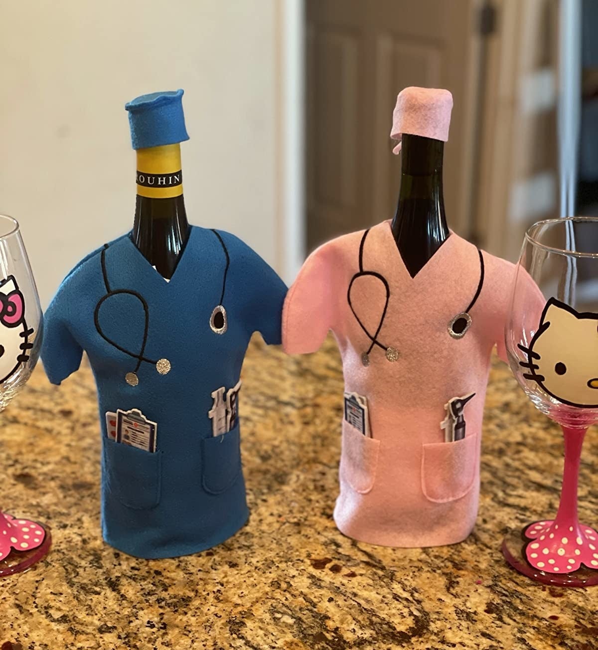 Reviewer photo of two bottles of wine, one in blue scrubs and the other in pink