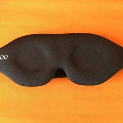 a reviewer showing the outer view of the sleep mask