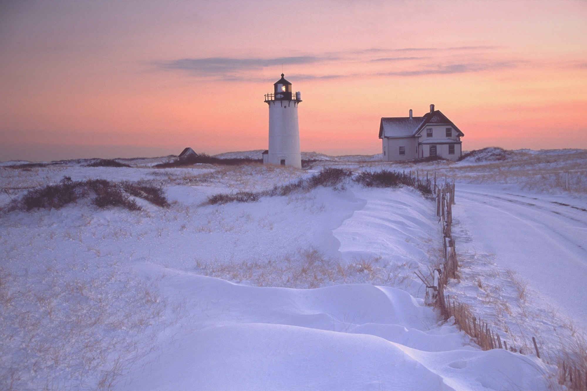 A lighthouse surrounded by snow.