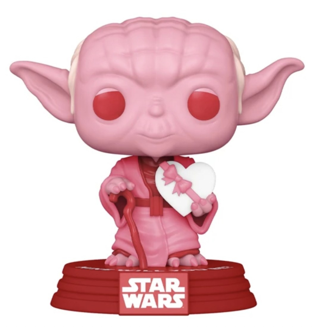 a Yoda figurine that is pink and red, and holding a Valentine&#x27;s Day chocolate heart