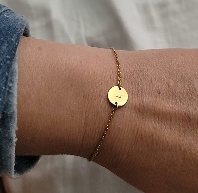 reviewer wearing the &quot;L&quot; initial coin bracelet