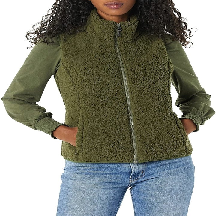 a model wearing the same vest in olive green
