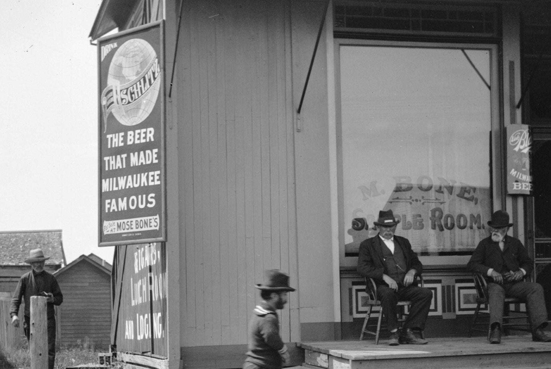 A Schlitz beer sign outside of a saloon