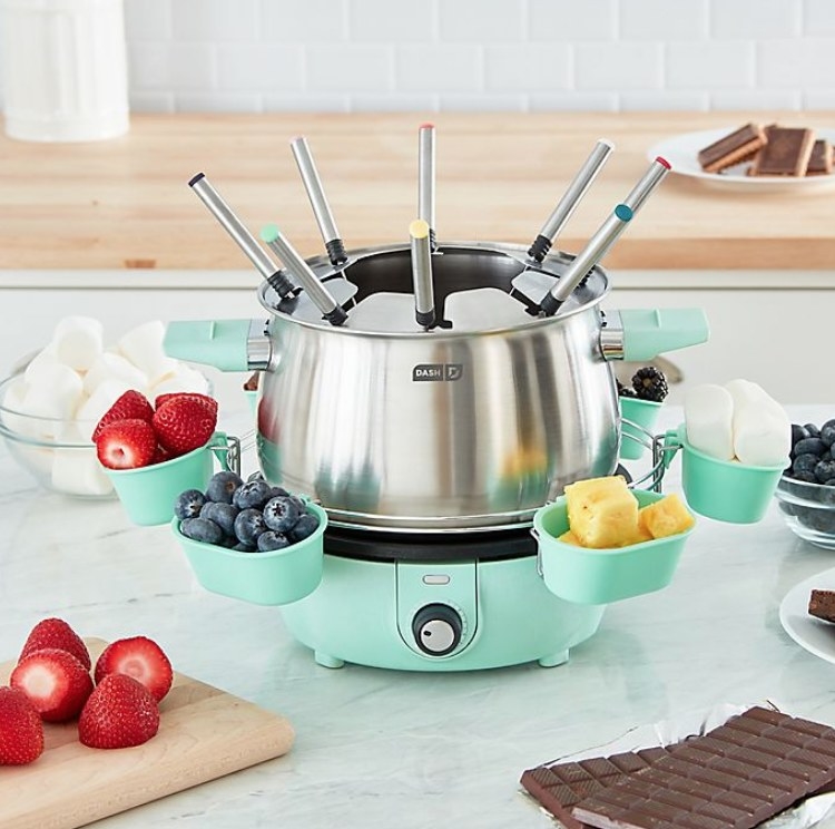 An aqua deluxe fondue set with eight color coated forks