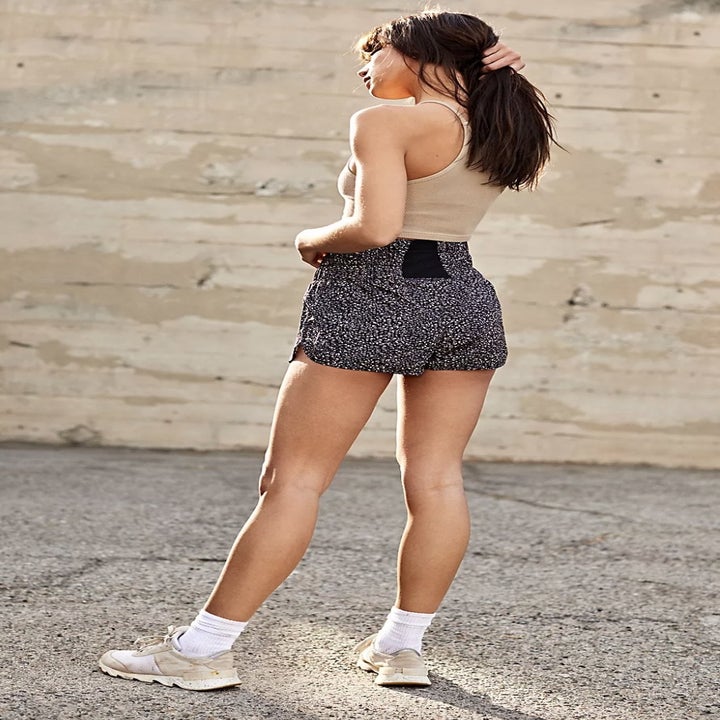 Model wearing printed running shorts