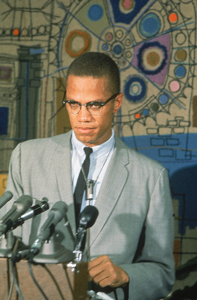 Malcolm X speaks to the press