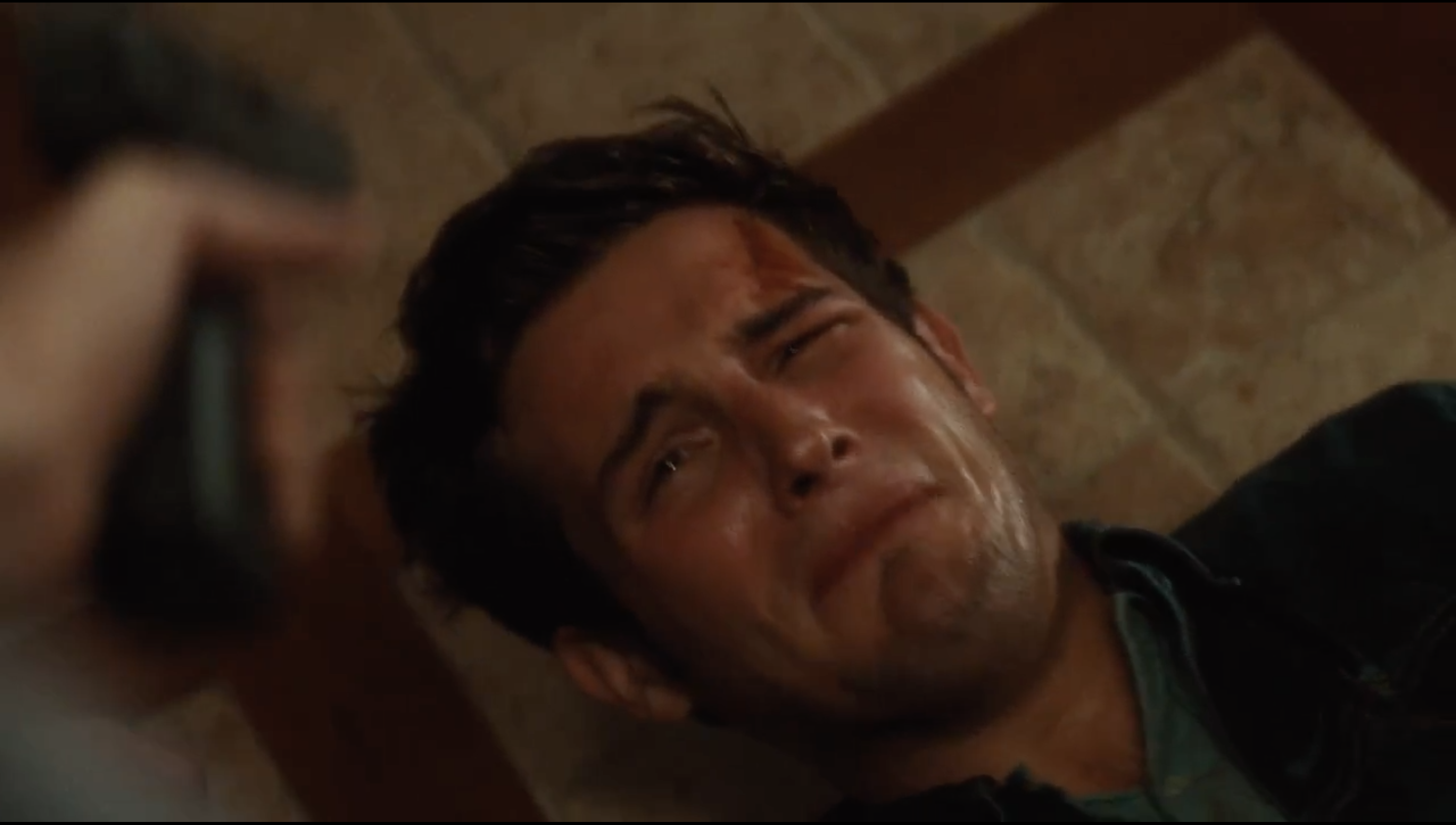 Nico Tortorella lies on the floor with a gun pointed at his head