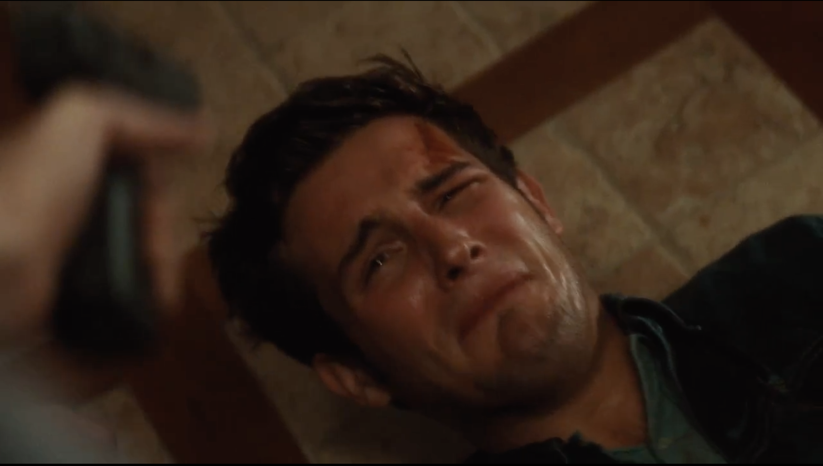 Nico Tortorella lies on the floor with a gun pointed at his head