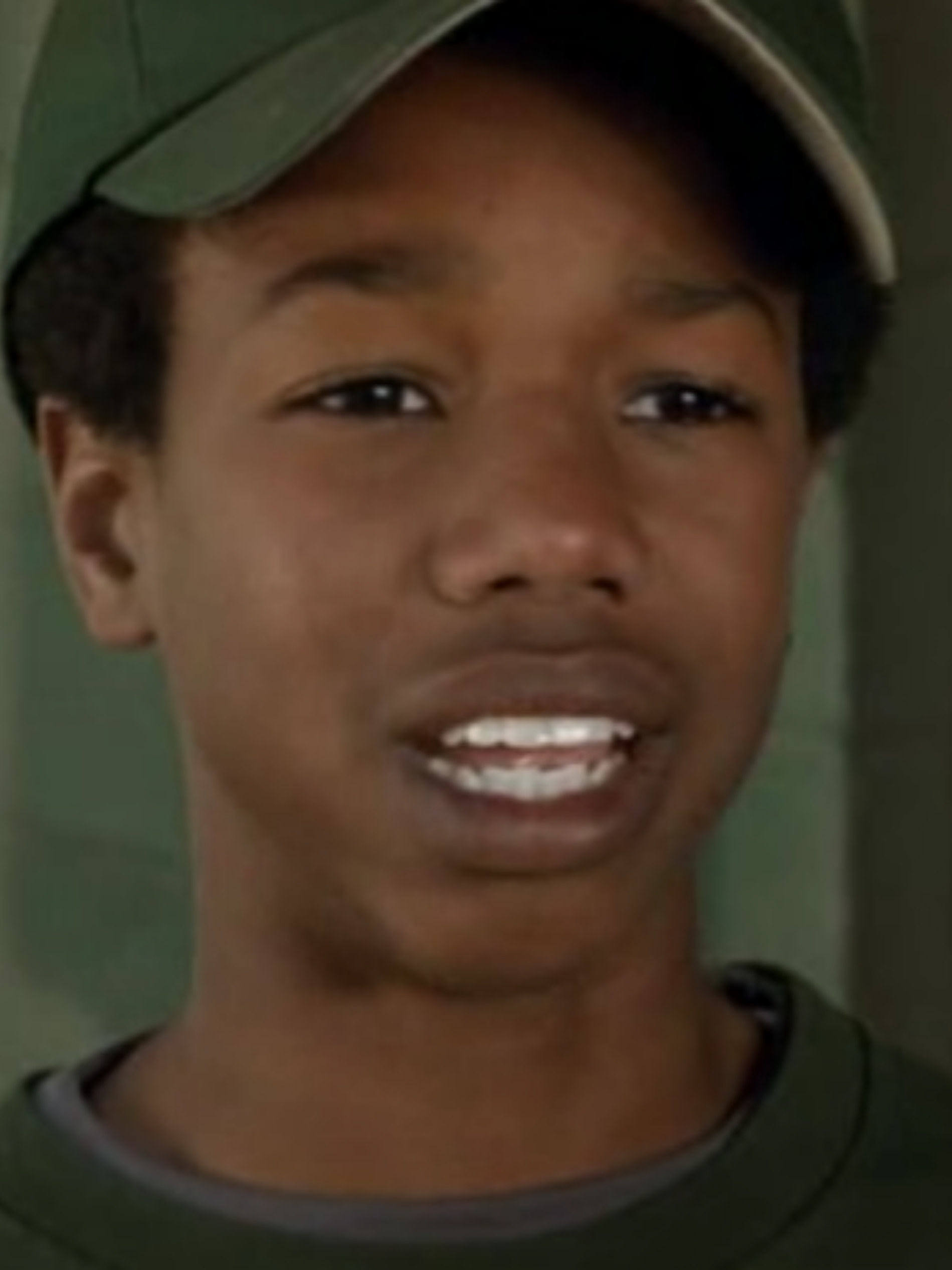 Jordan as a kid, wearing a baseball cap