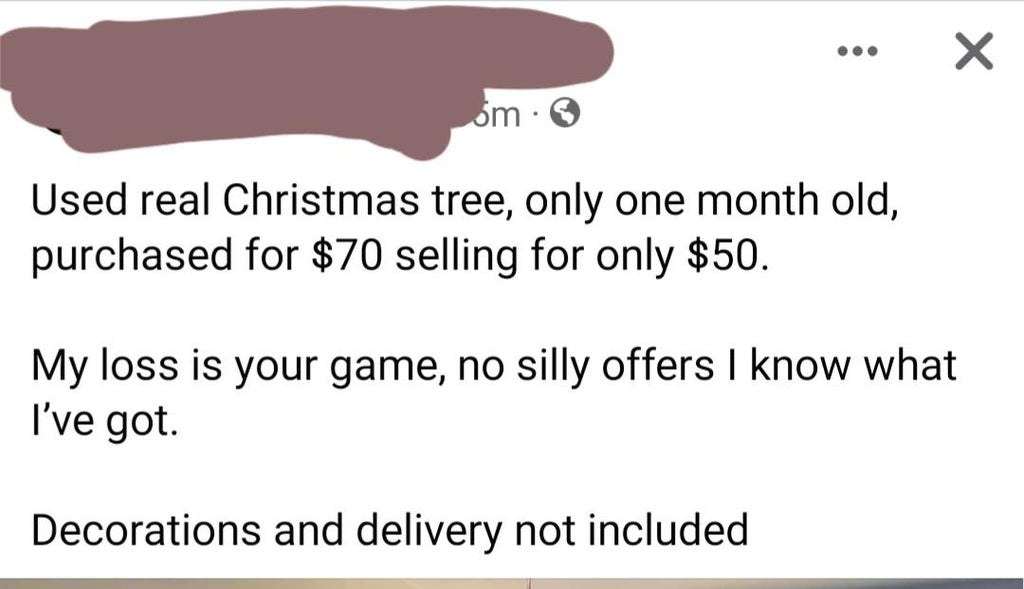 person trying to sell a used xmas tree