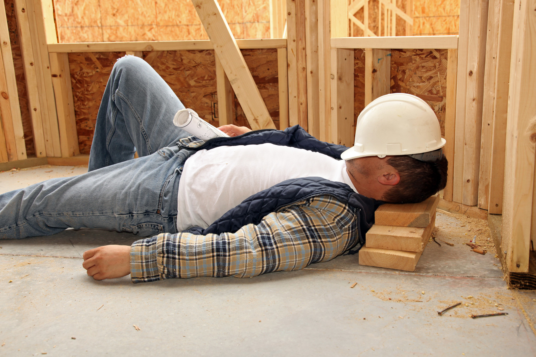 A construction worker sleeping on the job