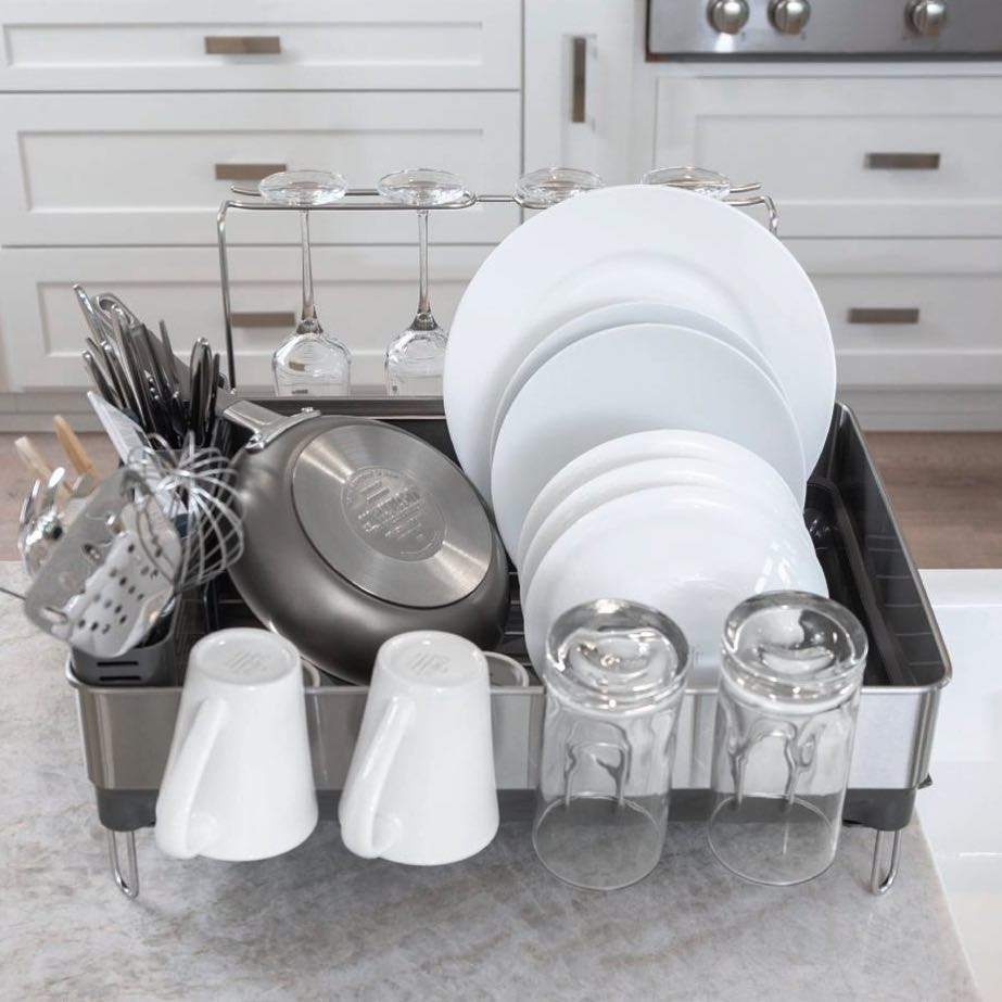 the dish drying rack filled with tons of dishes to show its different compartments