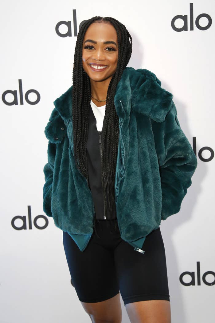 Lindsay poses for a photo with her hands in a coat