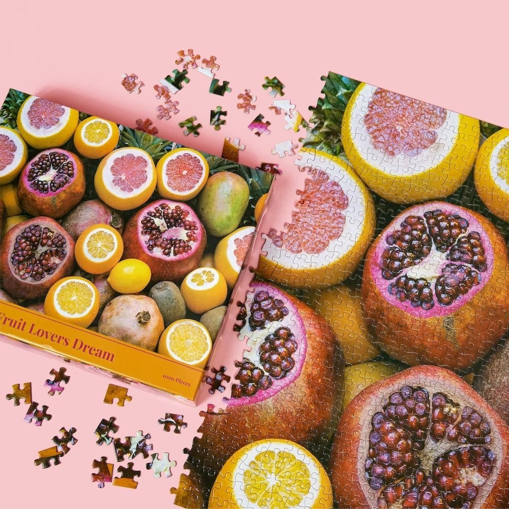 puzzle almost complete beside the packaging that shows the same image of several fruits