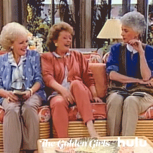 GIF women laughing on couch