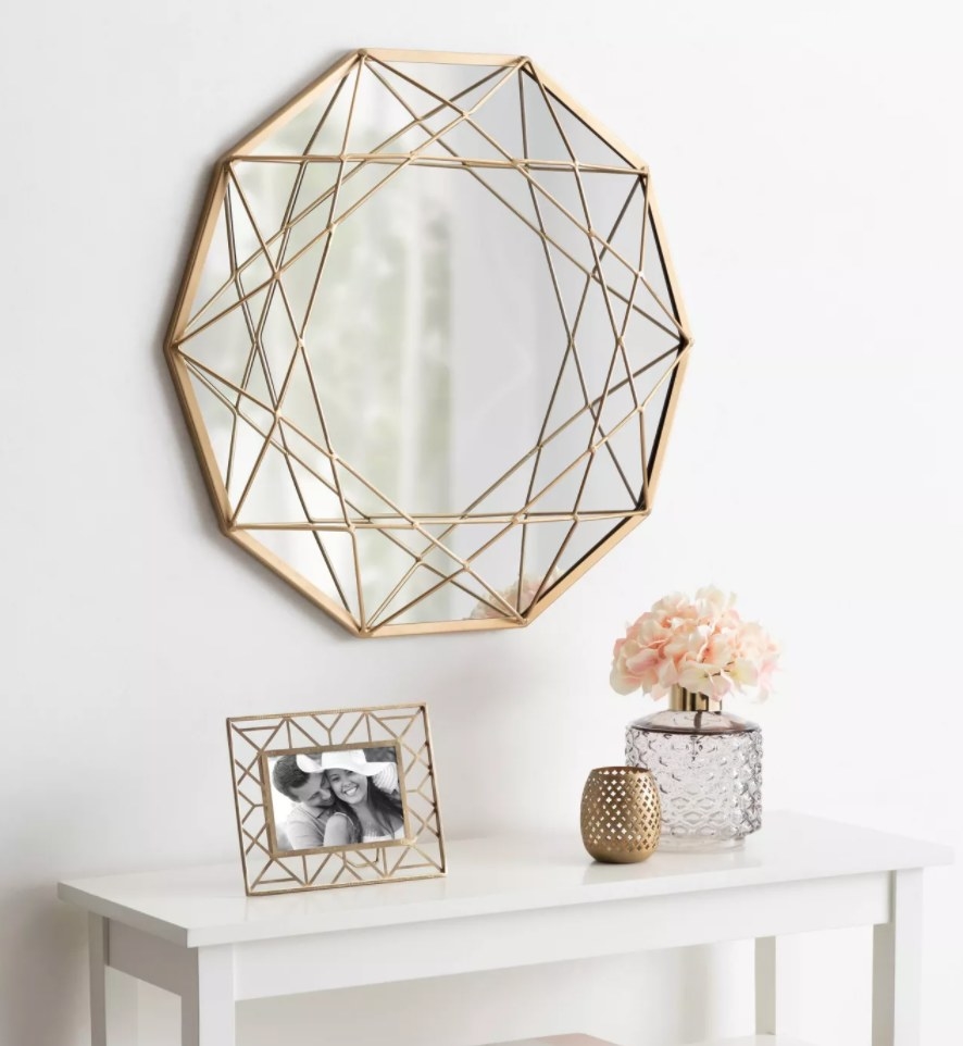 the geometric accent mirror hung on a wall