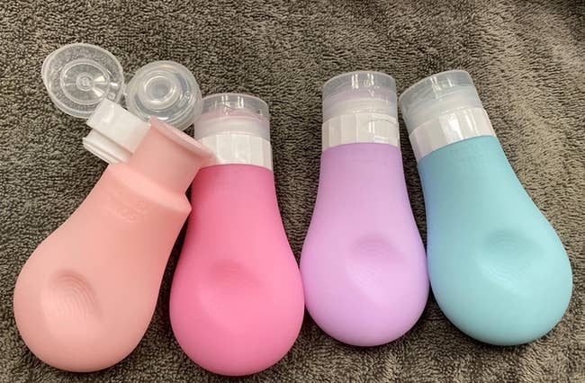Reviewer photo of four multicolored squeeze bottles