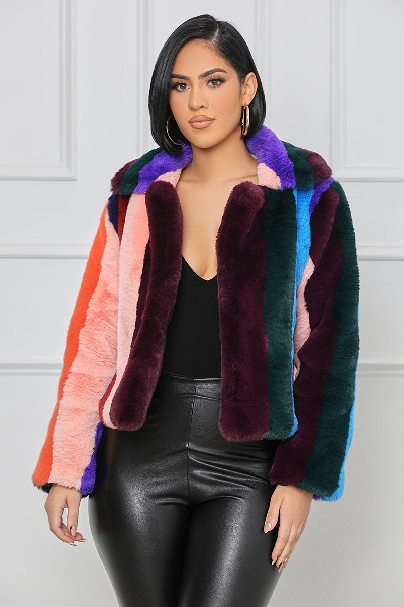 a model wearing the samba faux fur jacket over a black outfit