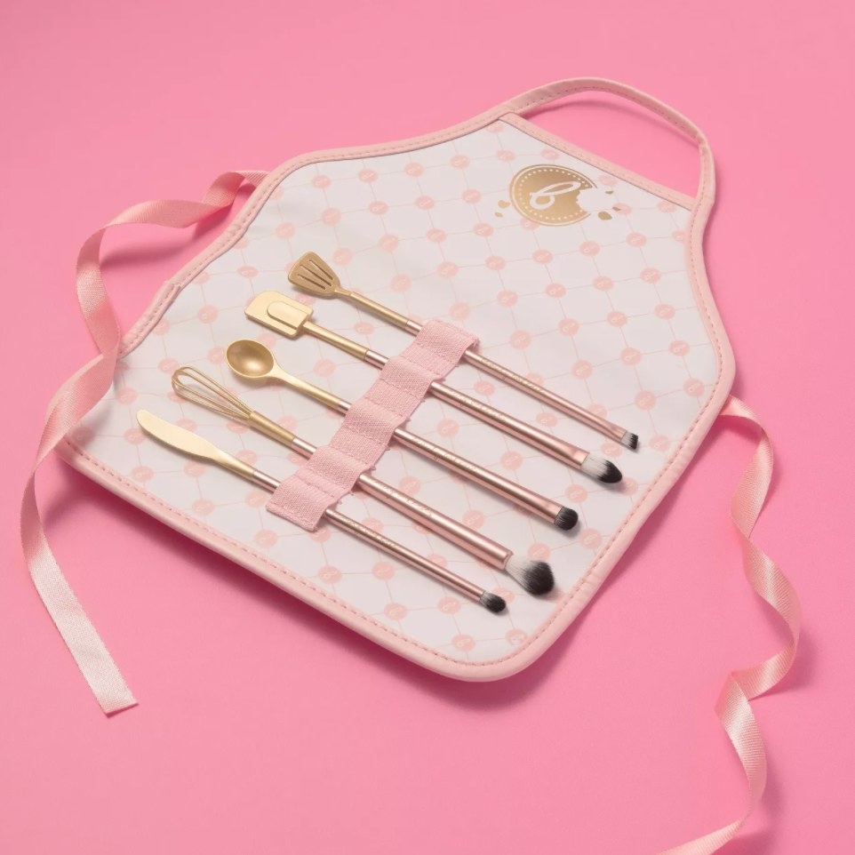 the makeup brush collection in an apron holder