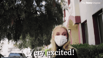 Emma in a mask saying, &quot;Very excited!&quot;