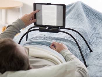 someone using the tablet stand in bed