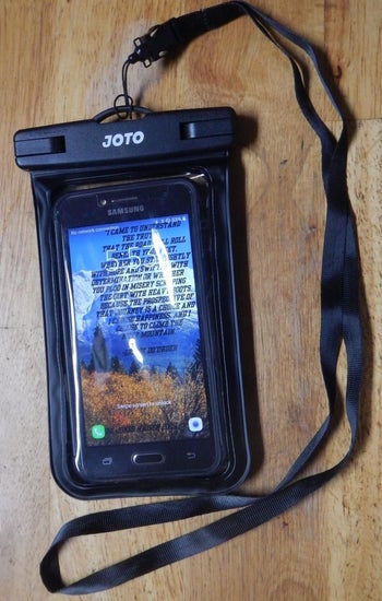a reviewer photo of the phone inside of the waterproof pouch