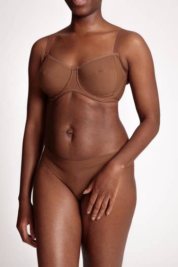 dark skinned model wearing the briefs, which are basically a perfect color match to their skin