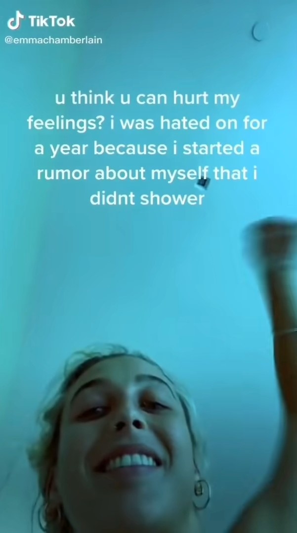 Emma smiling into the camera with text that says &quot;u think u can hurt my feelings? i was hated on for a year because i started a rumor about myself that i didn&#x27;t shower&quot;