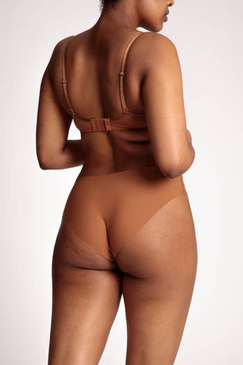 shot of a model's backside showing the panties lie flat and are almost a perfect match for their skin tone