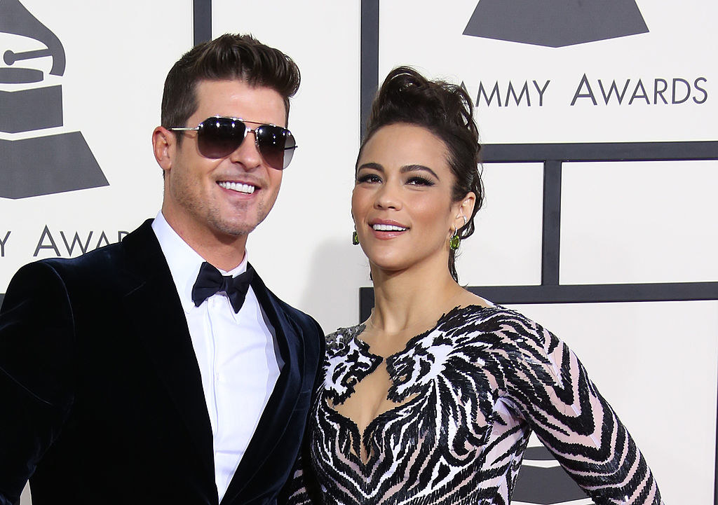 Robin Thicke and Paula Patton posing on the Grammys red carpet