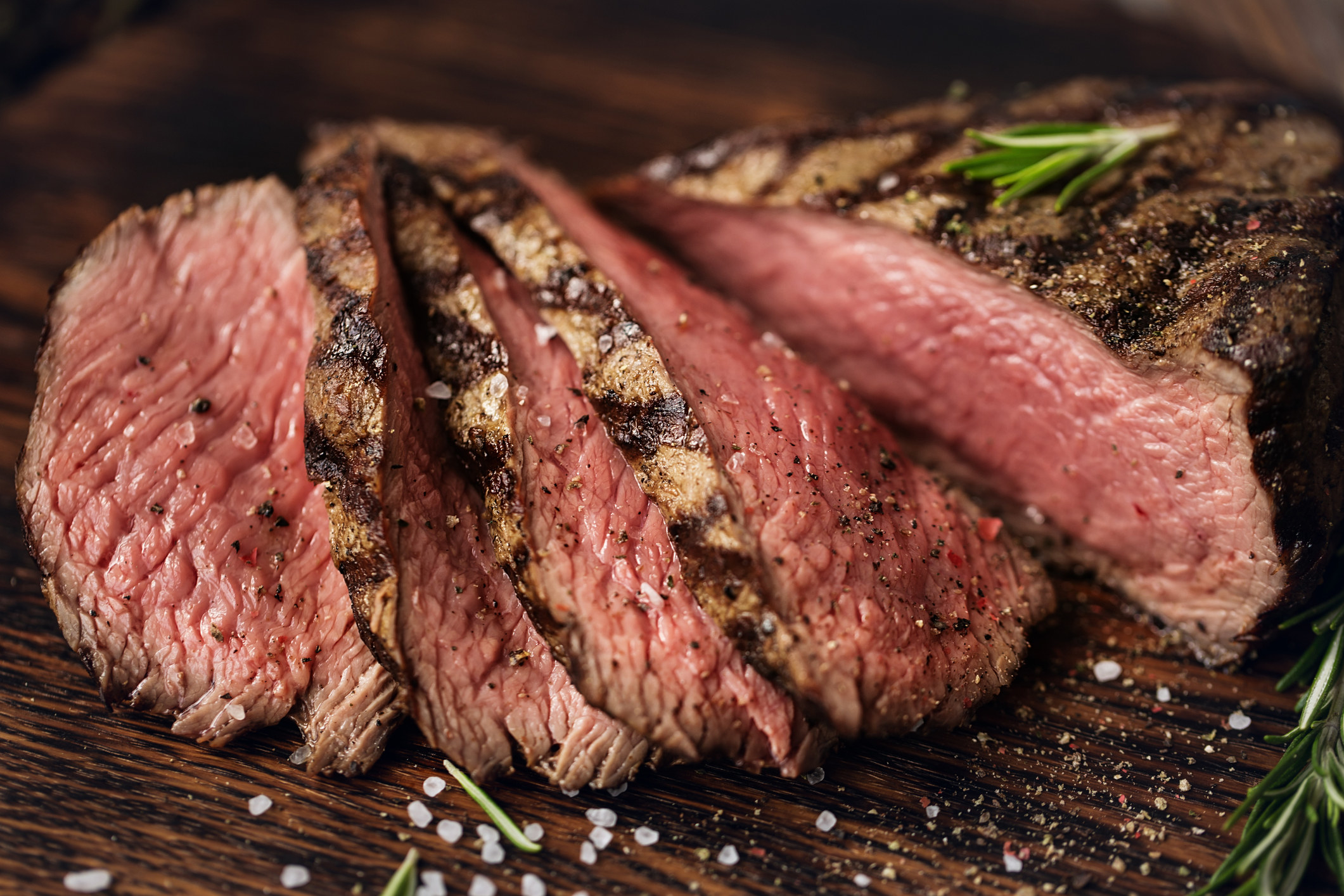 Medium rare steak sliced on cutting board