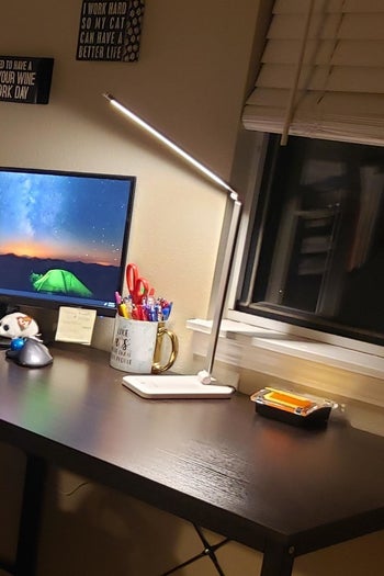 LED desk lamp angled over a workspace
