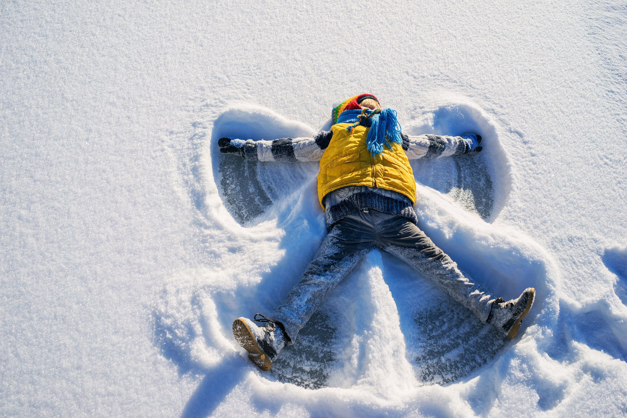 Boy making a snow angel