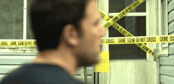 Ben Affleck looking behind him and then ahead at a crime scene in &quot;Gone Girl&quot;