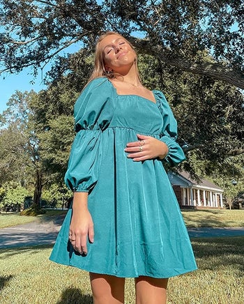 reviewer wearing the turquoise dress