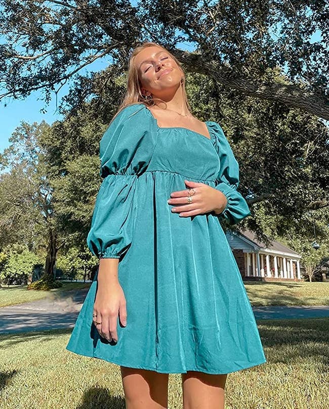 reviewer wearing the turquoise dress