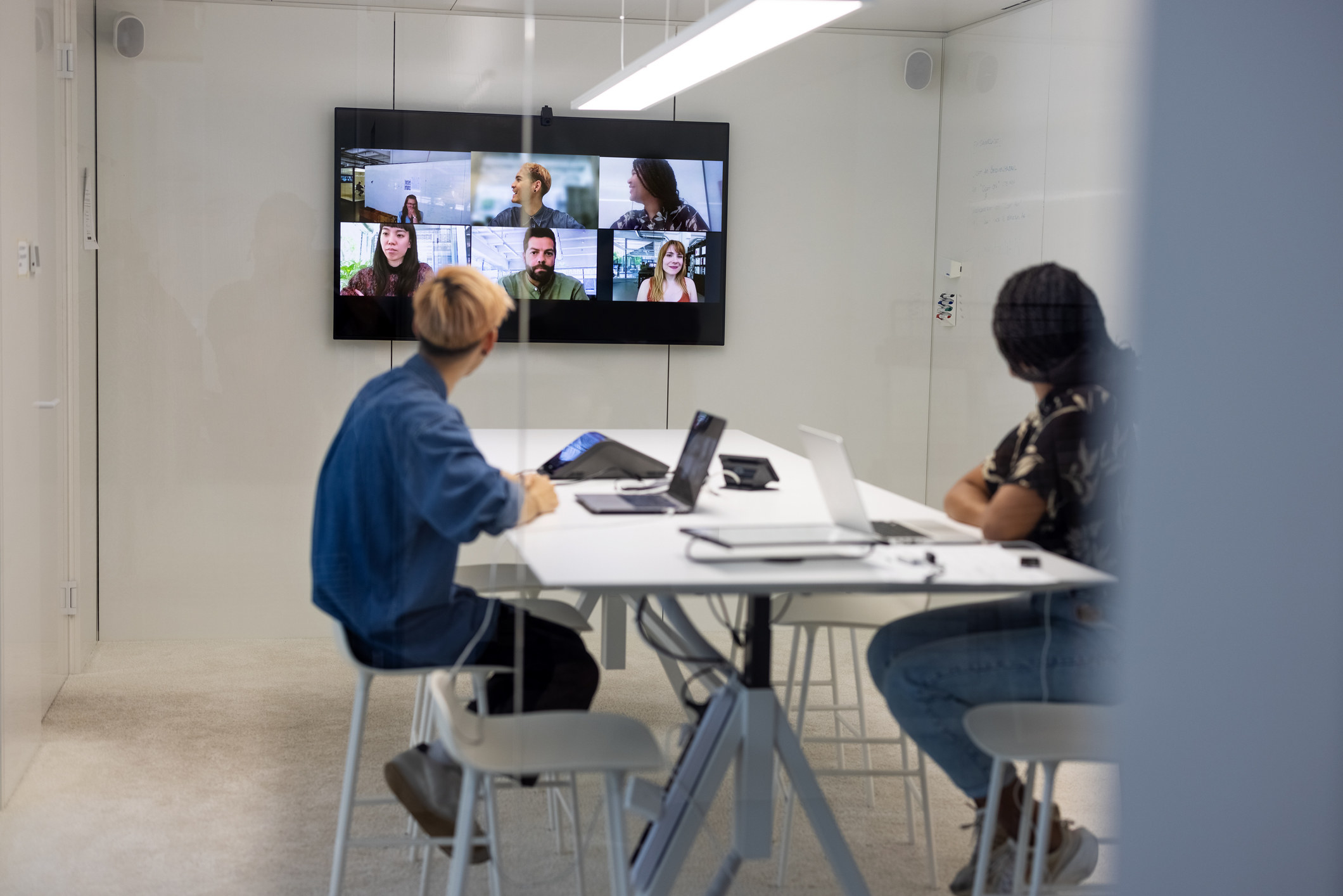 Workers in an office in a Zoom meeting