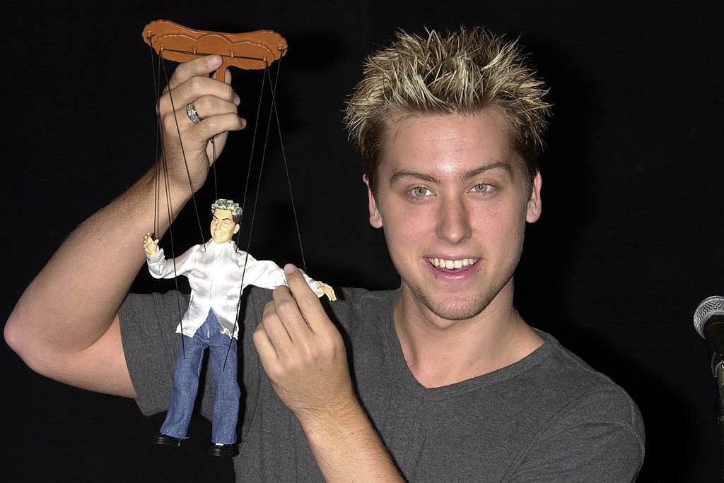 lance is holding an nsync marionette