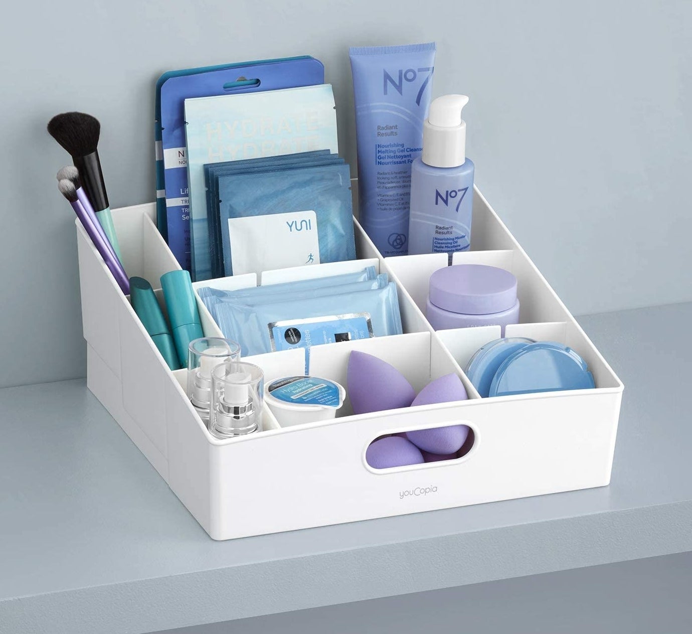 a tiered organizing bin filled with personal care products