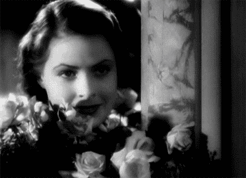 Ingrid Bergman smiling with flowers