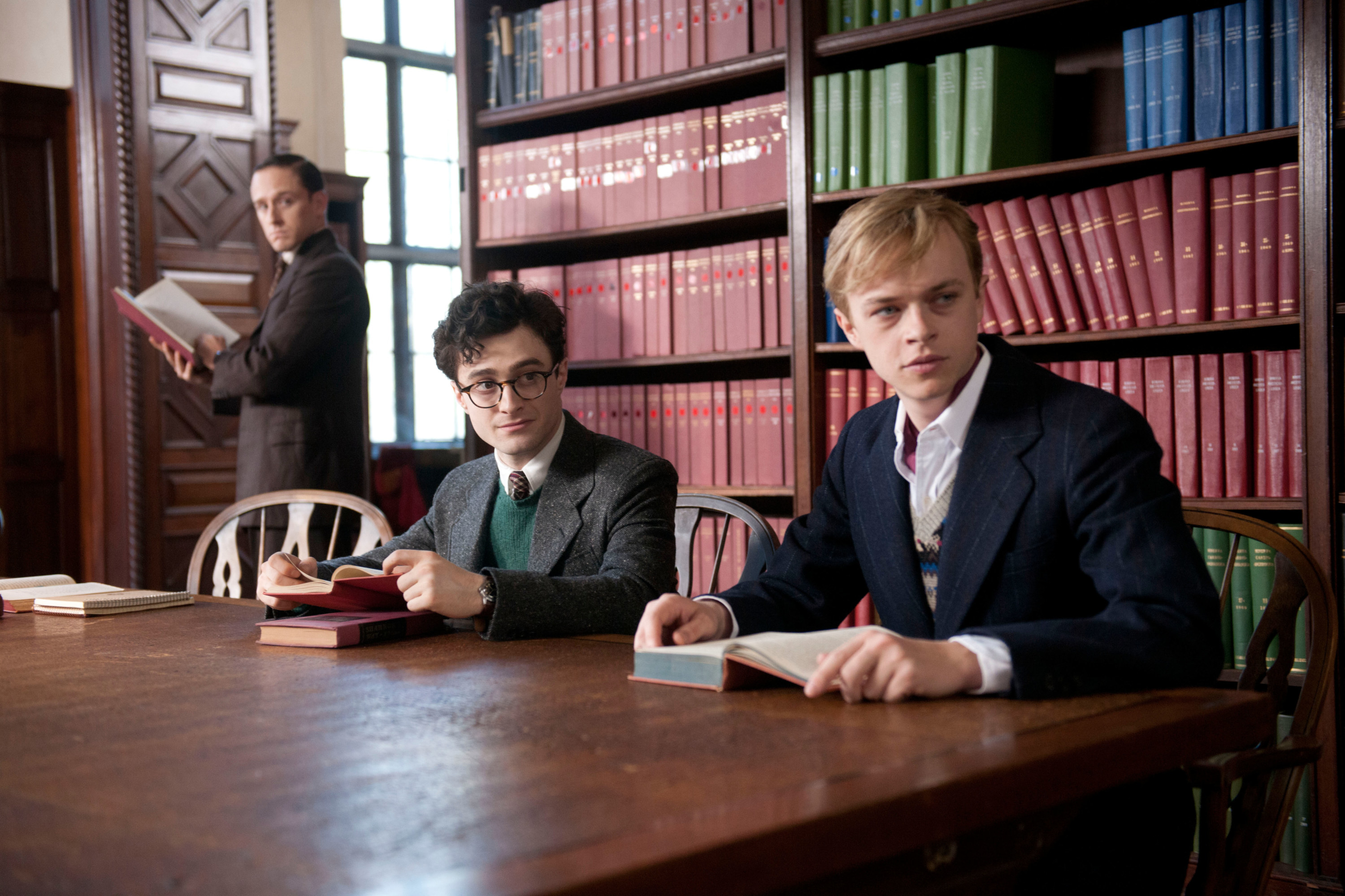 Daniel Radcliffe and Dane DeHaan sit at a table together