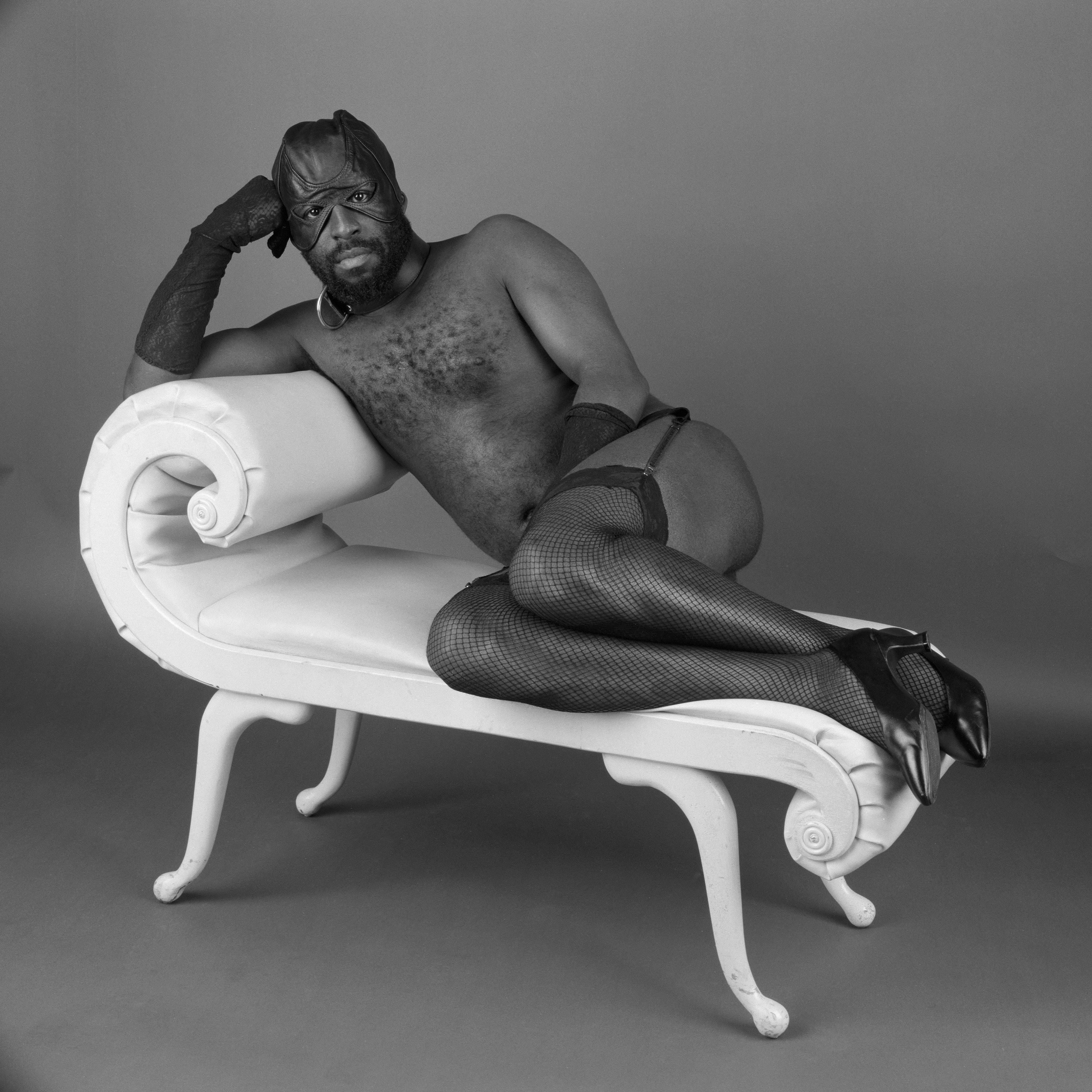&quot;Self-Portrait on Chez Lounge, 1998&quot;: The artist lies on his side, resting his hand on his long-gloved hand, on a chaise longue wearing fishnet stockings and heels only