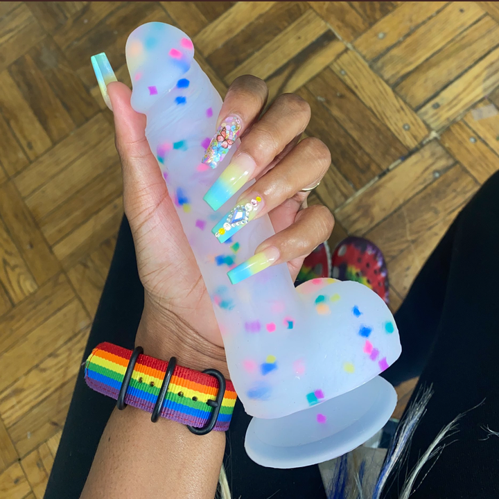 Model holding confetti dildo